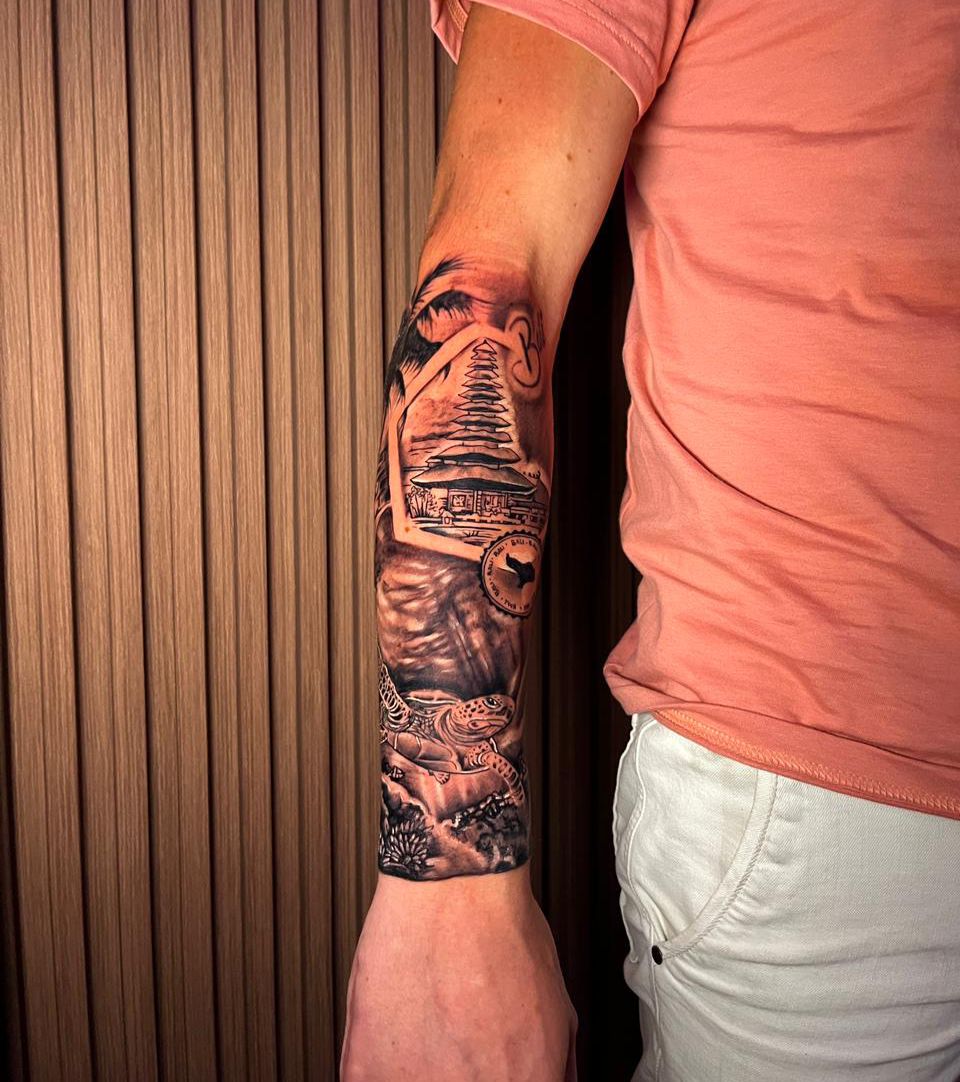 Intricate Bali-themed arm tattoo design