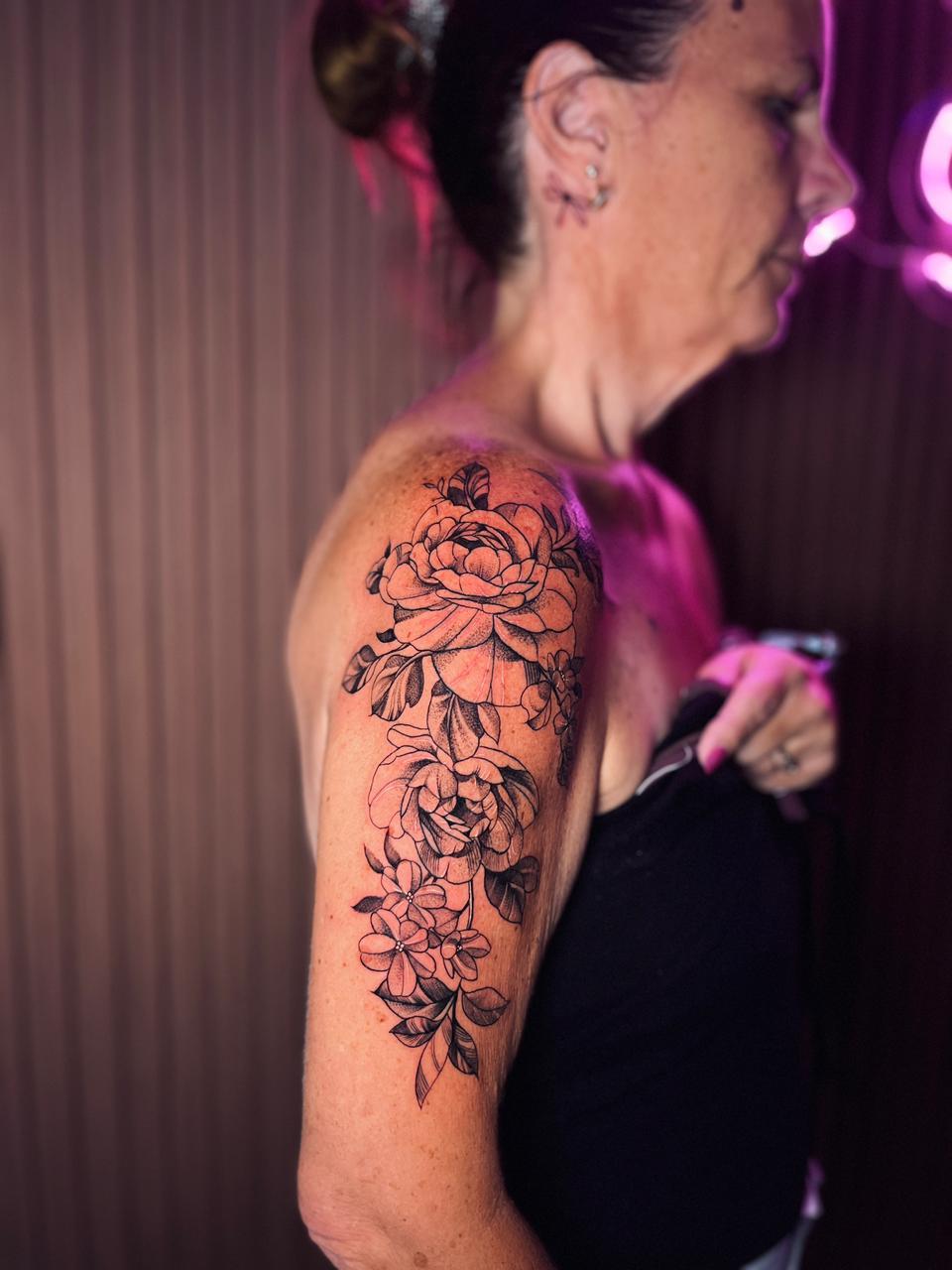 Woman with floral tattoo on arm