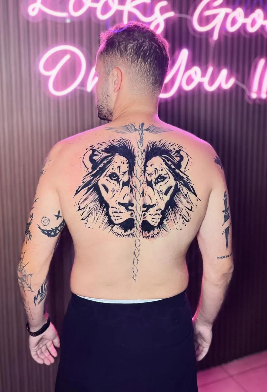 Man with lion tattoo on back