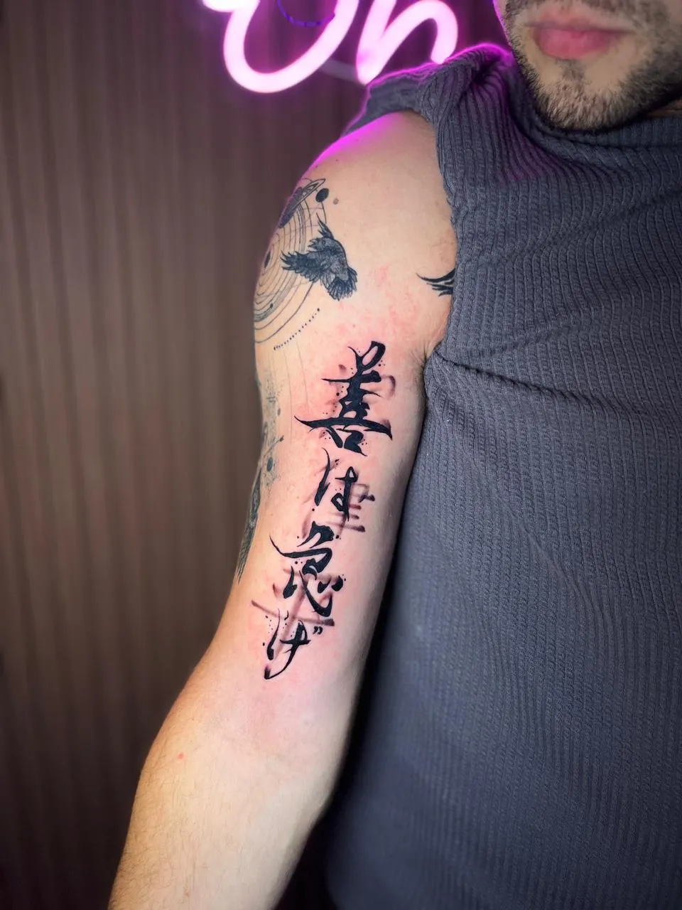 Tattoo with stylized text on arm
