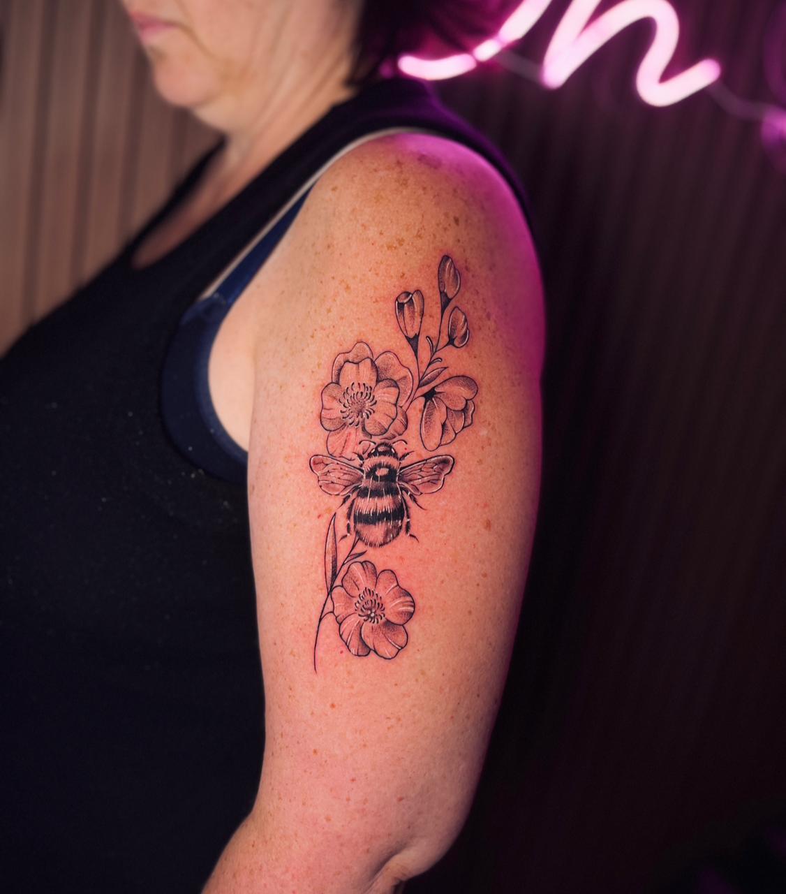 Bee and flowers tattoo on arm