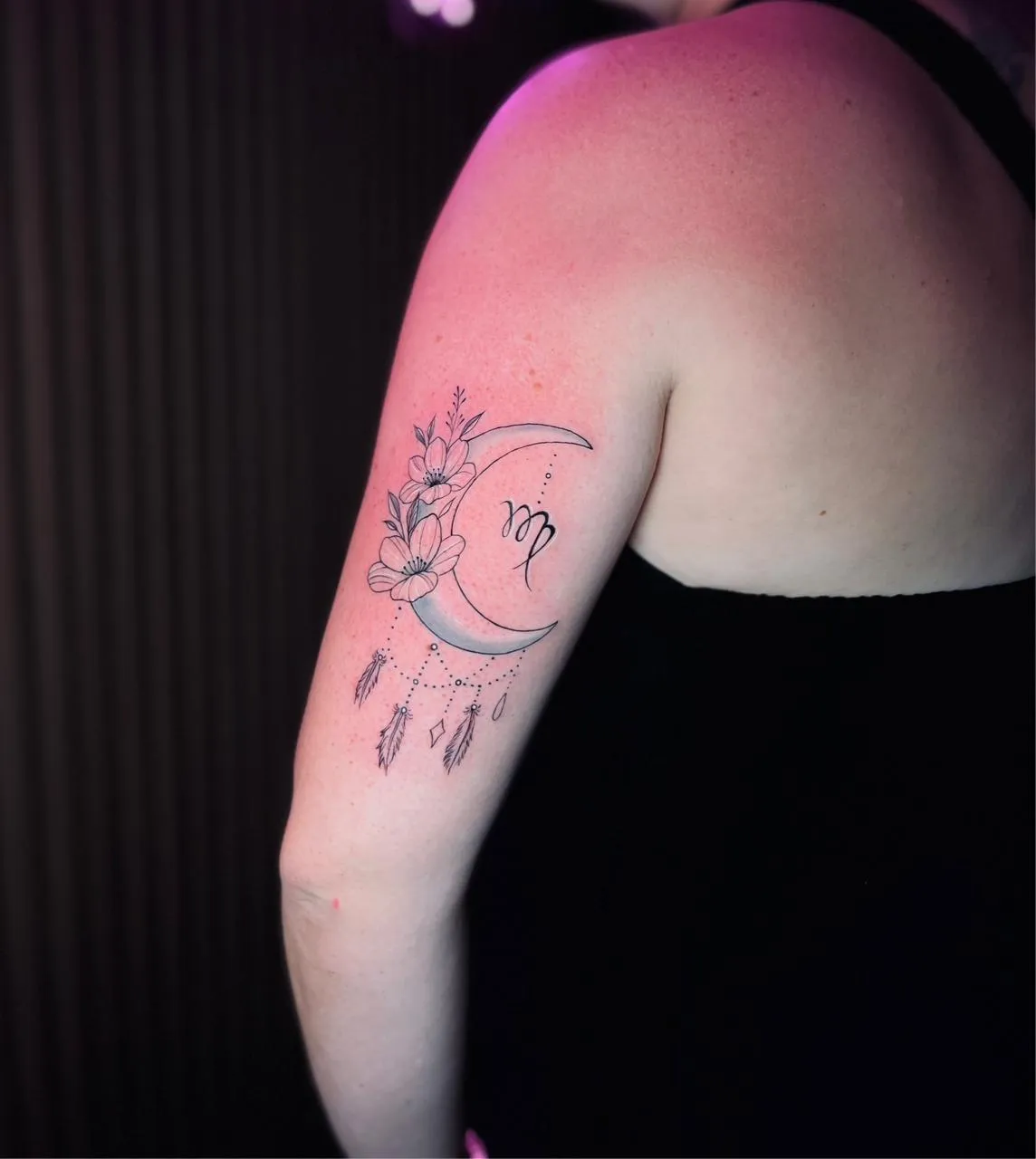 Floral crescent moon tattoo on arm